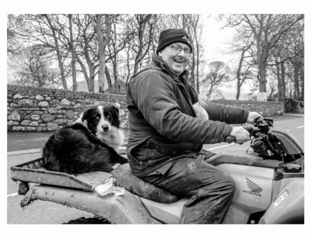 Farmer on quad bike with his dog in Dolgellau North Wales