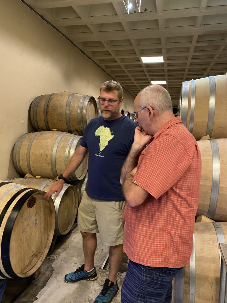 Dylan and Bevan with the oak barrels